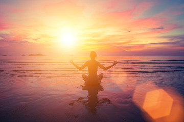 Sunset yoga on the beach, abstract photo about healthy lifestyle.