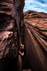 Smiling Hiker in Crack in the Wall Escalante Utah USA