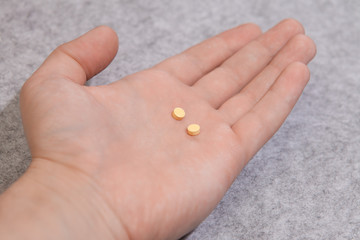 Medicine pills or capsules in hand, palm or fingers, receiving,