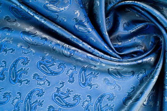 The texture of the silk fabric. Dark blue. With a picture of cucumbers