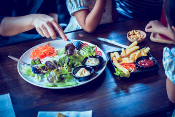 Salad on table with customer in cafe