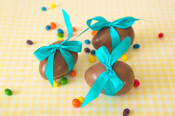 Chocolate Easter eggs over yellow tablecloth