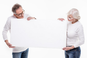 Senior beautiful couple with empty white board.