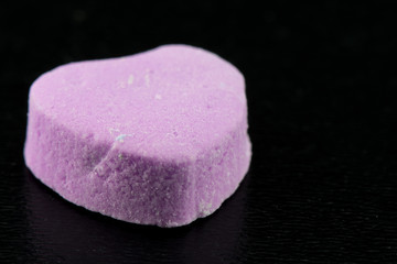 Obraz na płótnie Canvas Angle View of Blank Purple Candy Heart on Black