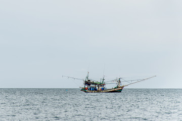Fototapeta premium Fishing boat big fishermen with fish net on the blue ocean catch fish
