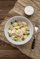 Meat dumplings - russian pelmeni, ravioli with meat on a white plate