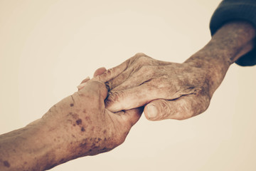 Elderly people holding hands together vintage