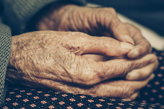 Old Asian female hands full of freckles and wrinkles at the age of more than 80 years old / Aging concept