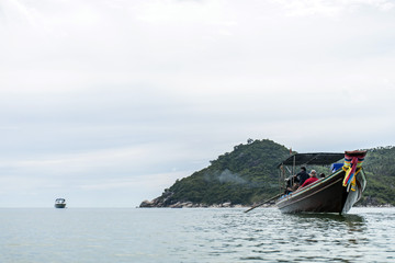 Thai traditional longtail boat tour big diesel engine in action smoke pollution