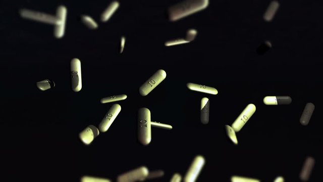 Percocets falling on black background