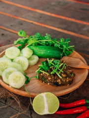 Vintage style Thai traditional food Nam Prik Num (Northern Thai Green Chilli Dip) on top and wooden background wallpaper