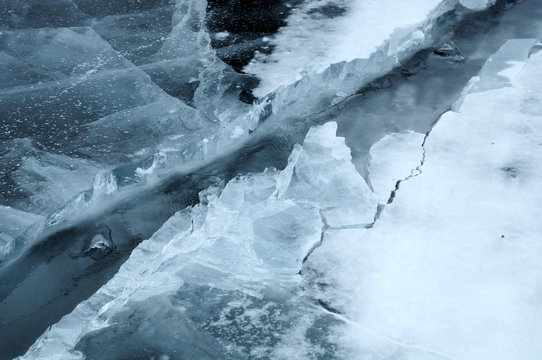 Ice hummocks on the northern shore of Olkhon Island on Lake Baikal. Fresh crack broke the thick ice. Fresh clean water rises from the depths and freeze in the cold. Ice Storm. Photo partially tinted