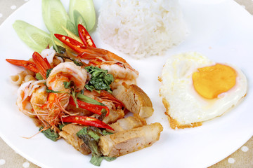 Jasmine rice topped stir - fried spicy basil with meat.