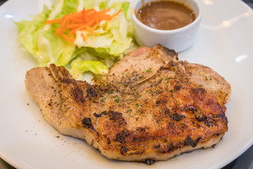 Pork pepper steak with vegetable on white plate