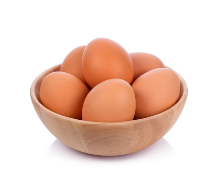 Eggs in wooden bowl isolated on white background