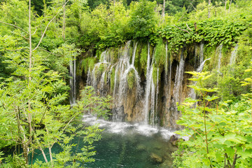Fototapeta na wymiar View overlooking waterfalls cascading down the karst formations in Plitvice Lakes National Park near Entrance 1 on the H trail.