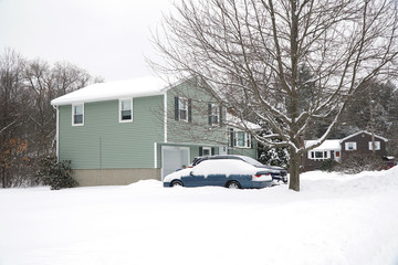 house in residential area after snow