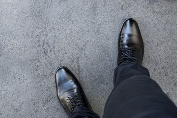 Top view of businessman legs wearing black shoes walking go to dream