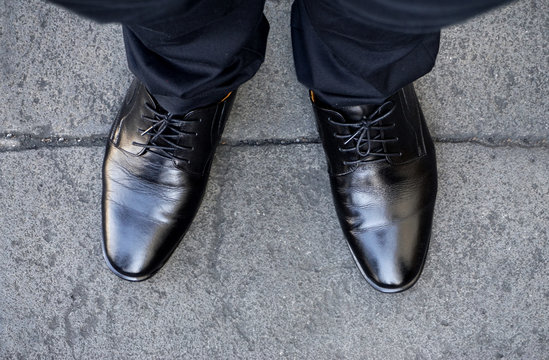 Top view of businessman legs wearing black shoes walking go to dream