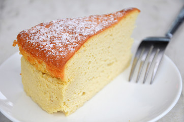 Yellow cheese cake on table