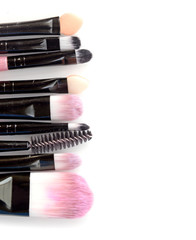 Various makeup brushes isolated over white background
