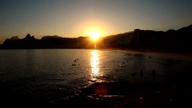 Sunset at the Arpoador Beach in Rio de Janeiro, it is a popular surf spot.