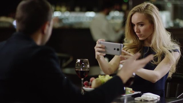 glamour girl taking a selfie in a pompous cafe
