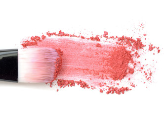 Close up of crushed blush on white background and cosmetic brush