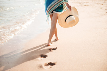 Cropped image of woman walking on sand