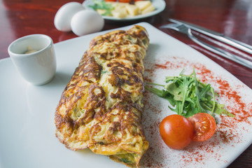 Breakfast - omelette with cherry tomato and greens