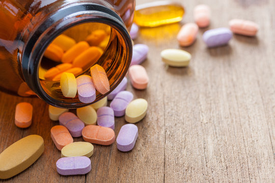 Vitamin C pills on a wooden table, supplemental diet, healthcare and wellness concept