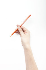 A woman hand hold a orange pencils isolated white.