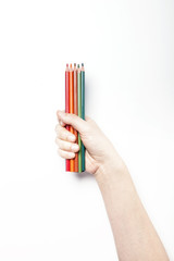 A woman hand hold color pencil isolated white.