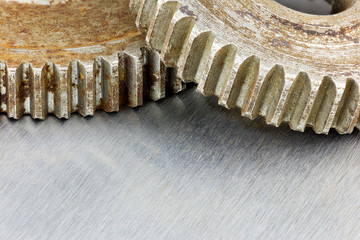 old rusty metal gearwheels on scratched industrial background macro