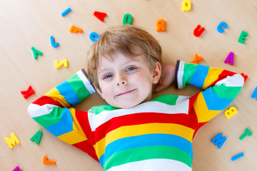 Kid boy with colorful numbers, indoor
