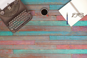 Vintage typewriter and coffee on wood background