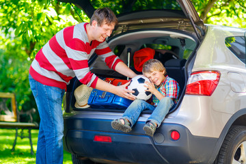 Little kid boy and father before leaving for car vacation