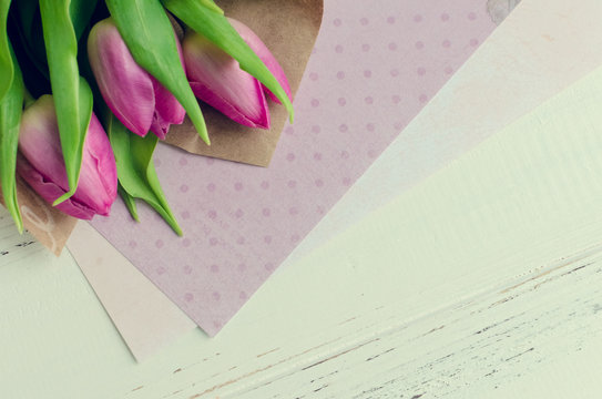 Pink tulips on white shabby chic background
