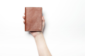 woman hand hold a brown leather wallet with name card or credit card isolated white.