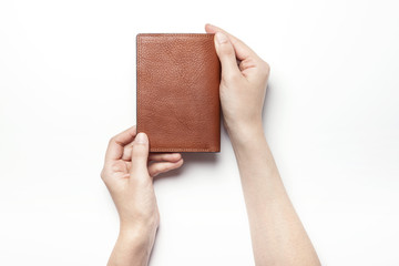 woman hand hold a brown leather wallet with name card or credit card isolated white.