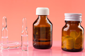 Brown glass pill bottles and three medicine ampules