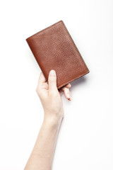 woman hand hold a brown leather wallet with name card or credit card isolated white.