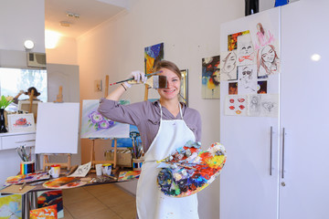 Women beautiful painter posing and smiling, laughing into camera