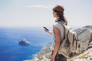 Hiking woman using smart phone, travel and active lifestyle concept
