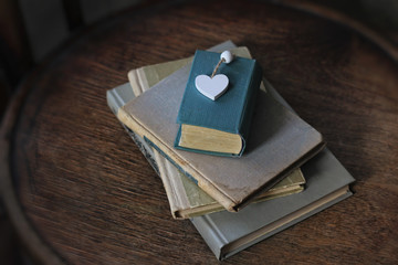 old books and heart  on wooden table, abstract background. love of reading, Literature and knowledge concept.  World Book and Copyright Day, 23 April