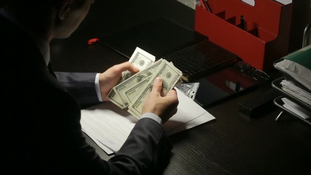 corruption, bribery and fraud concept - close up of businessman taking money