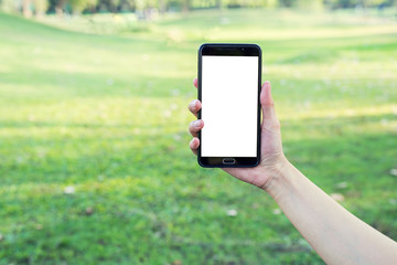 Hand holding smartphone on glass background