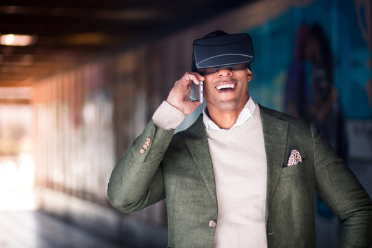 Man talking phone in VR goggles