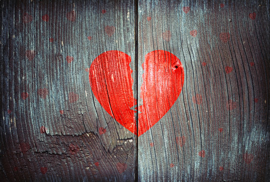 Old  blue and brown wood texture with painted broken love heart symbol.