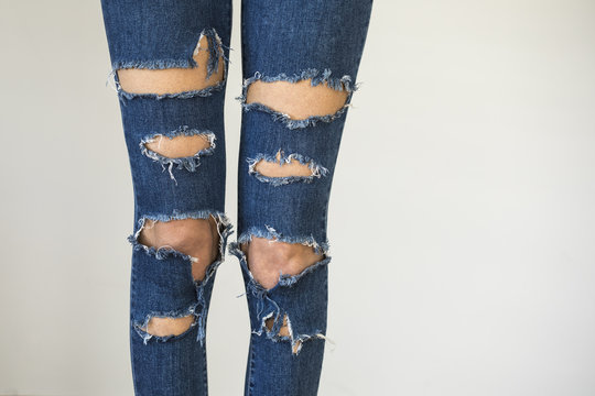 Woman in fashionable ripped Jeans